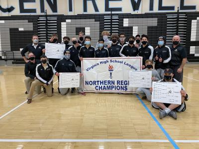 Wrestling team posing with the regional banner! Regional champs hold their brackets